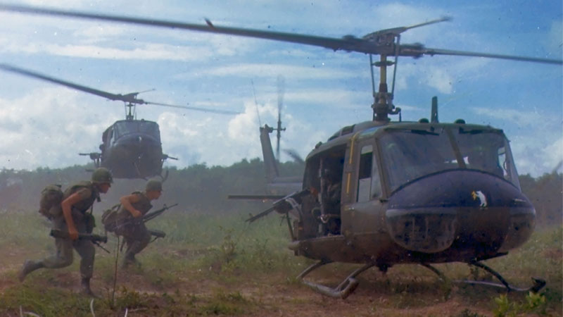 Soldiers running to a helicopter.